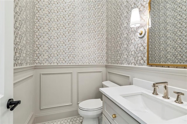 bathroom with tile patterned flooring, toilet, and vanity