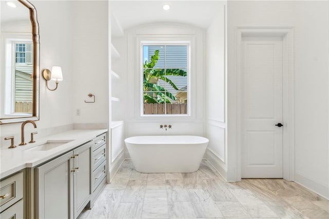 bathroom with plenty of natural light, vanity, and tile patterned flooring