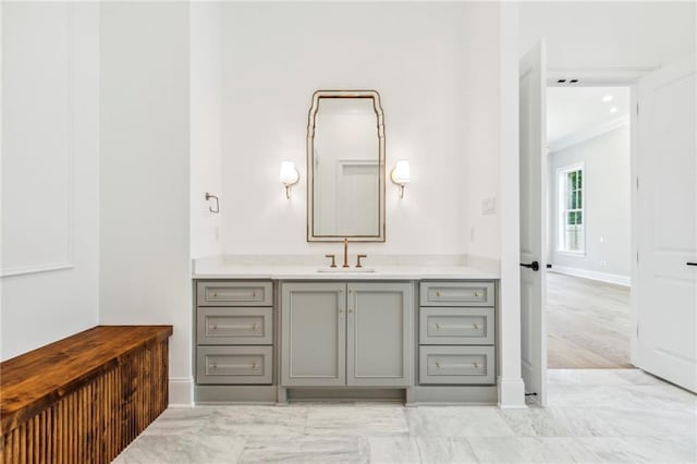 bathroom with ornamental molding, vanity, and hardwood / wood-style flooring