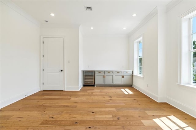 unfurnished bedroom with multiple windows and light wood-type flooring