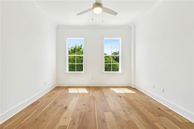 empty room featuring crown molding, light wood-type flooring, and ceiling fan