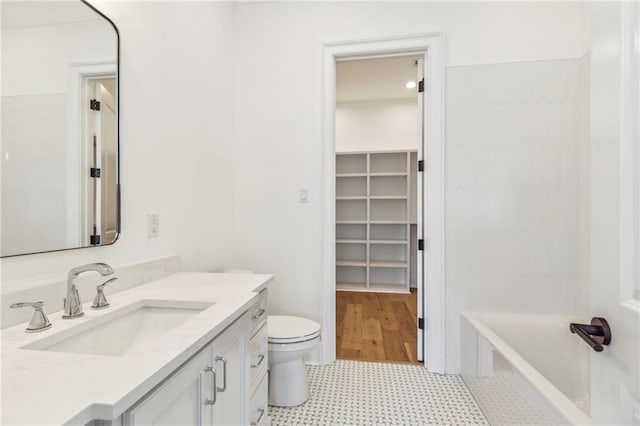 bathroom featuring vanity, toilet, and tile patterned floors