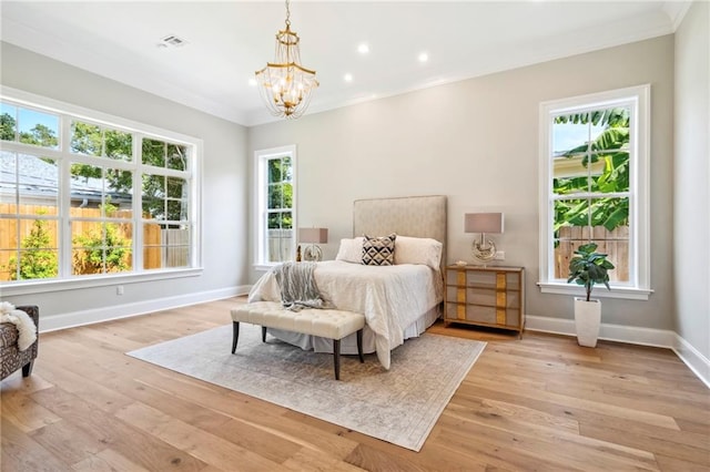 bedroom with multiple windows, ornamental molding, and light hardwood / wood-style floors