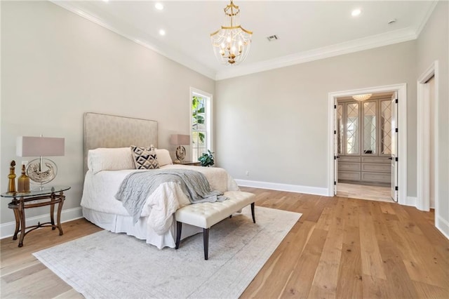 bedroom with an inviting chandelier, wood-type flooring, and crown molding