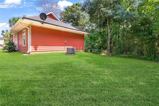 exterior space with a yard and central AC