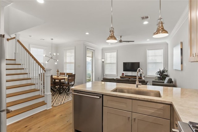 kitchen featuring sink, hanging light fixtures, light hardwood / wood-style floors, crown molding, and dishwasher