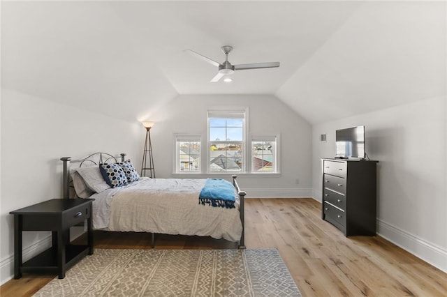 bedroom with lofted ceiling, a ceiling fan, baseboards, and wood finished floors