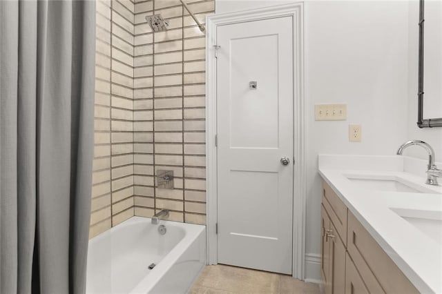 bathroom with double vanity, tile patterned flooring, a sink, and bathing tub / shower combination