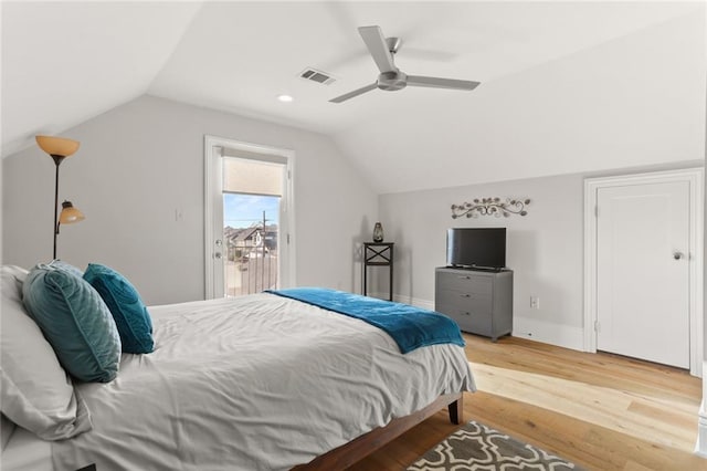 bedroom featuring light hardwood / wood-style flooring, access to outside, ceiling fan, and vaulted ceiling