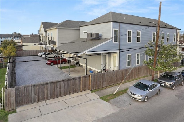 view of front of property featuring fence and a residential view