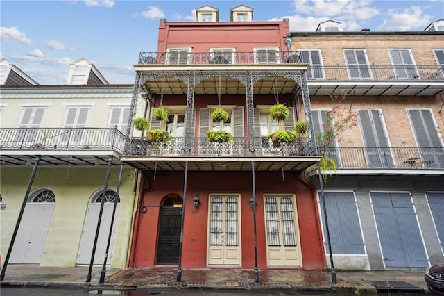 rear view of property with a balcony