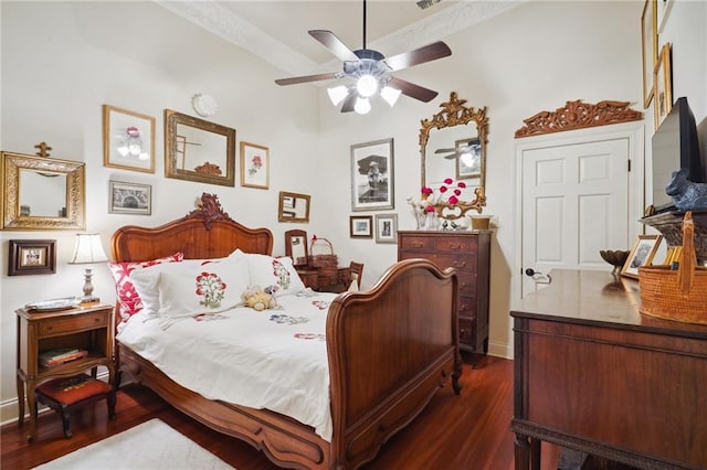 bedroom with ceiling fan and dark wood-type flooring