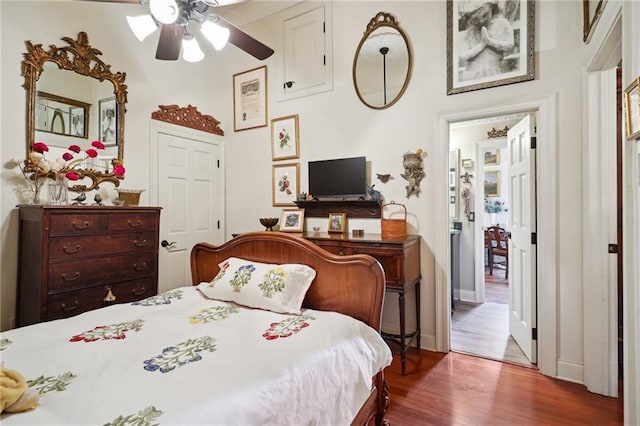 bedroom with dark hardwood / wood-style floors and ceiling fan