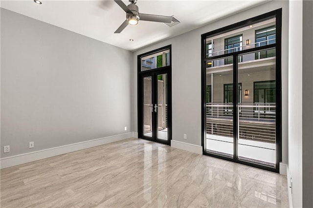 spare room featuring french doors and ceiling fan