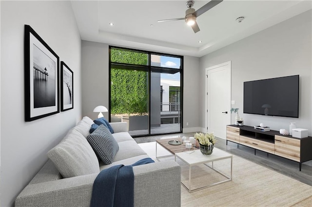 living room featuring ceiling fan and light wood-type flooring