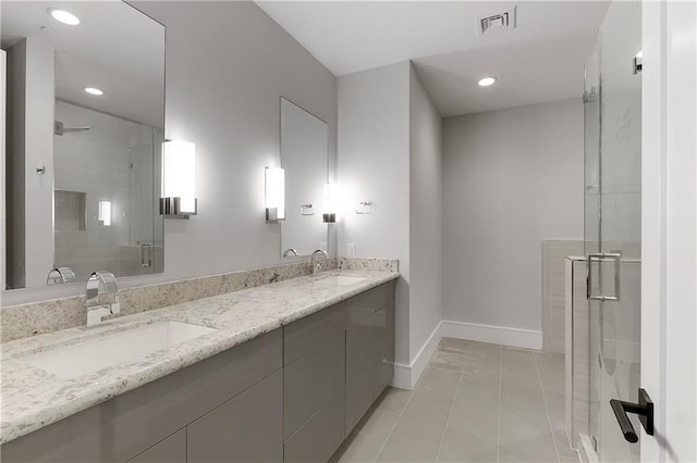 bathroom with tile patterned floors, vanity, and an enclosed shower