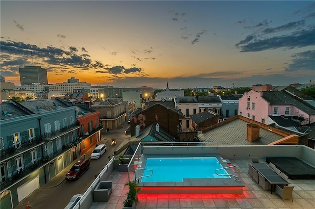 view of pool at dusk