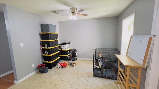 misc room featuring light tile patterned floors and ceiling fan