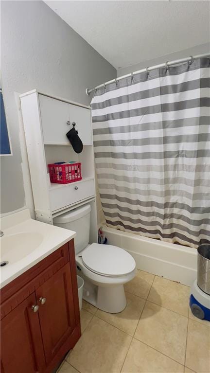 full bathroom featuring tile patterned flooring, vanity, toilet, and shower / bath combo with shower curtain