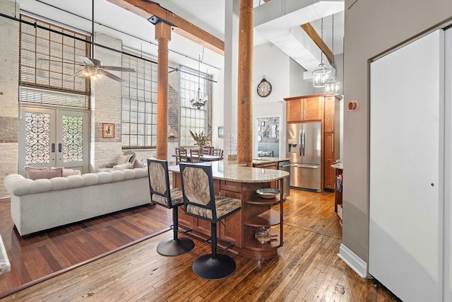 dining room featuring high vaulted ceiling, french doors, wood-type flooring, and ceiling fan