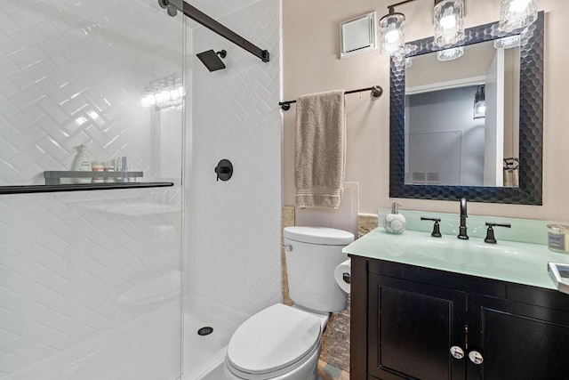 bathroom featuring walk in shower, toilet, and vanity