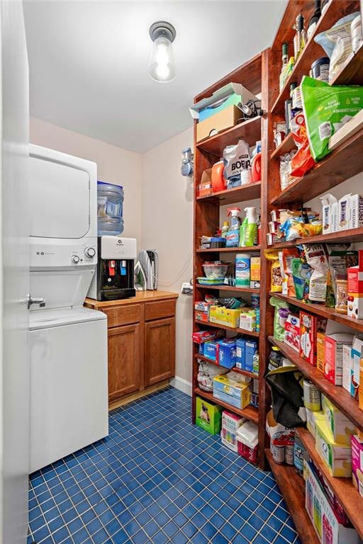 pantry with stacked washer and dryer