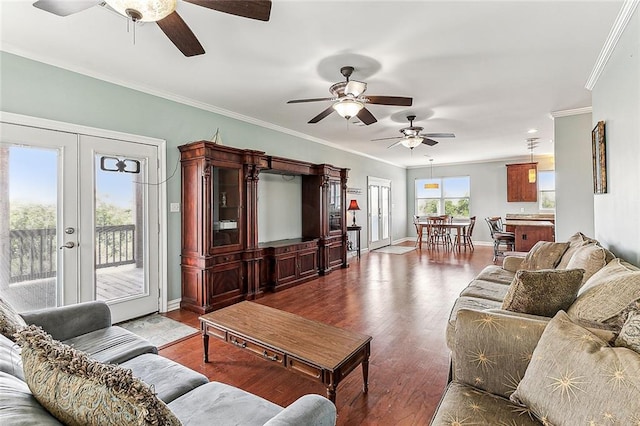 living room featuring french doors, ornamental molding, and light hardwood / wood-style flooring