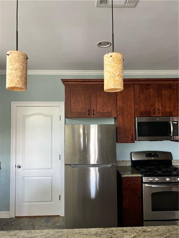 kitchen with stone counters, ornamental molding, pendant lighting, and appliances with stainless steel finishes