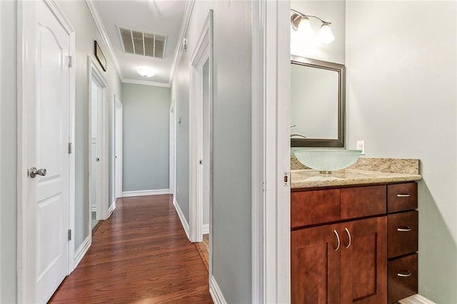 bathroom with vanity, wood-type flooring, and crown molding