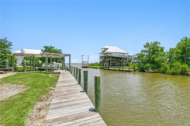 view of dock with a yard and a water view