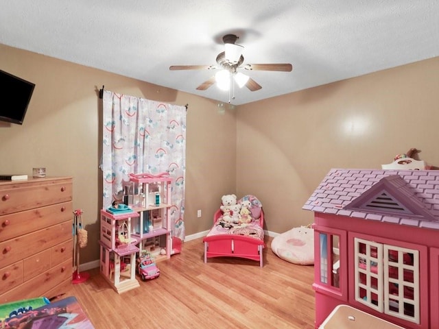 rec room with hardwood / wood-style flooring and ceiling fan