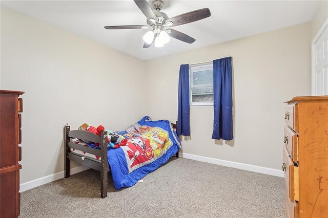 carpeted bedroom featuring ceiling fan