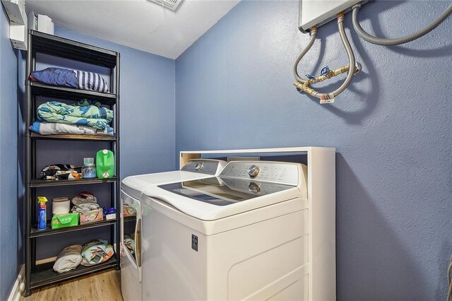 washroom featuring light hardwood / wood-style floors and independent washer and dryer