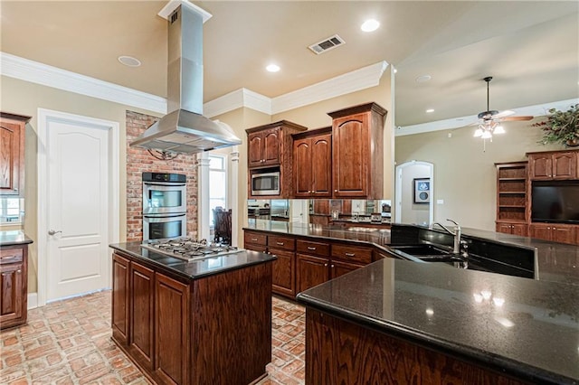 kitchen with sink, stainless steel appliances, crown molding, island range hood, and a kitchen island