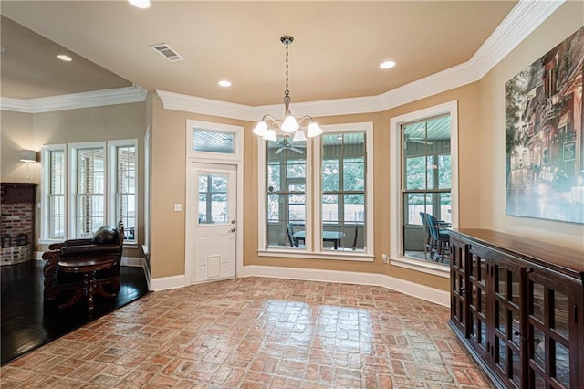 interior space featuring ornamental molding and an inviting chandelier