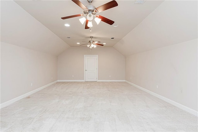 additional living space with light colored carpet, vaulted ceiling, and ceiling fan