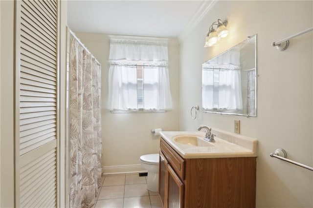 bathroom with toilet, tile patterned flooring, crown molding, vanity, and a closet