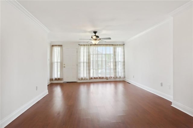 empty room featuring ceiling fan, baseboards, ornamental molding, and dark wood finished floors