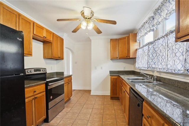 kitchen featuring dark countertops, black appliances, arched walkways, and a sink