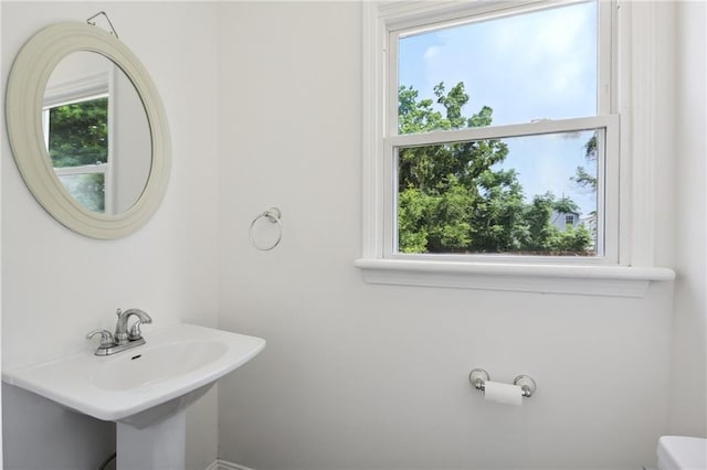 bathroom with toilet and a sink