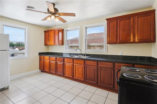 kitchen featuring light tile patterned floors, electric range, a sink, a ceiling fan, and freestanding refrigerator