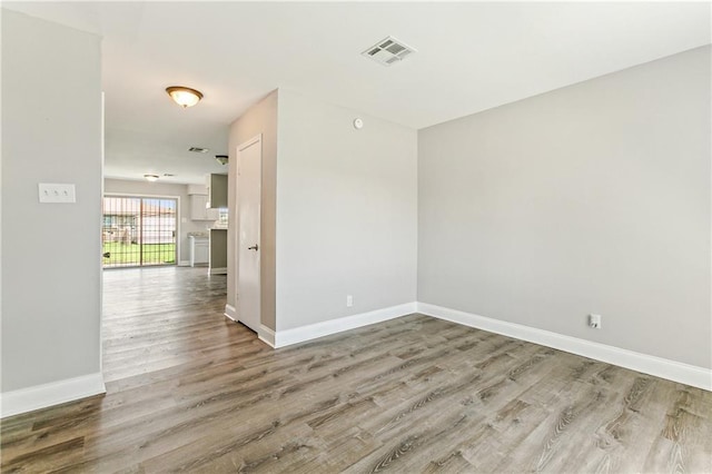 unfurnished room with hardwood / wood-style flooring