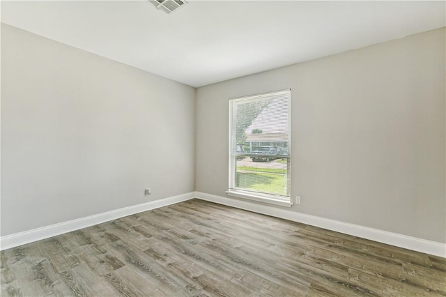 unfurnished room with hardwood / wood-style floors