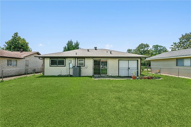 back of property with cooling unit and a lawn