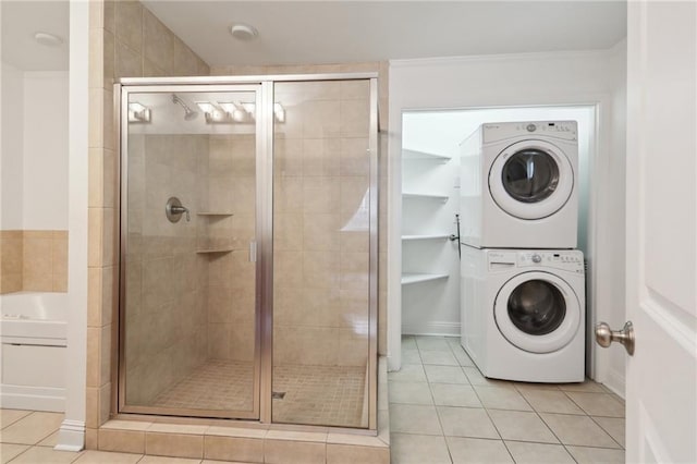 bathroom with separate shower and tub, tile patterned flooring, stacked washer / drying machine, and ornamental molding