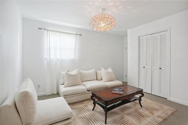 living room featuring carpet floors and an inviting chandelier