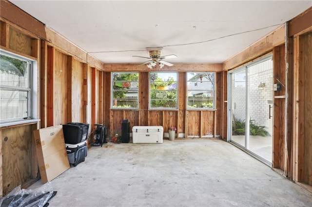 unfurnished sunroom featuring a wealth of natural light and ceiling fan