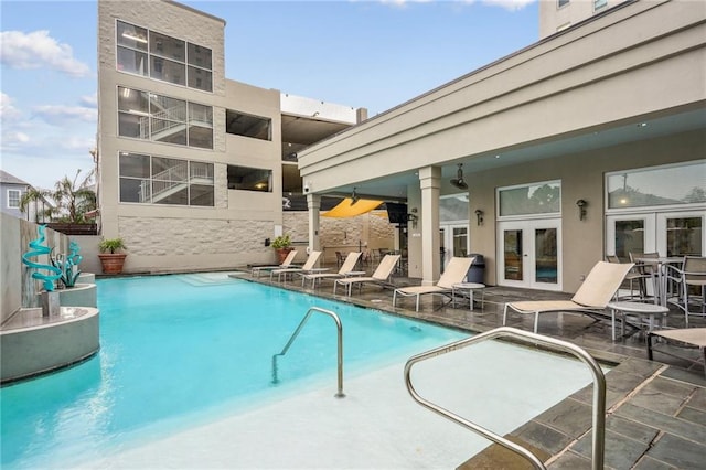 view of pool featuring a patio area and french doors