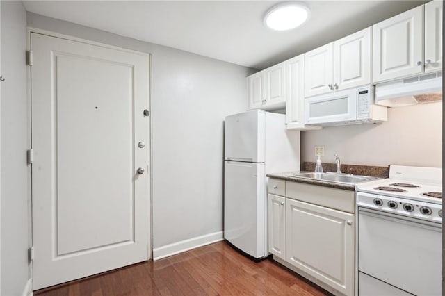 kitchen with hardwood / wood-style floors, white appliances, premium range hood, sink, and white cabinetry