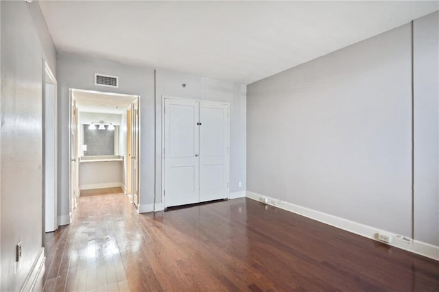 unfurnished bedroom featuring hardwood / wood-style flooring